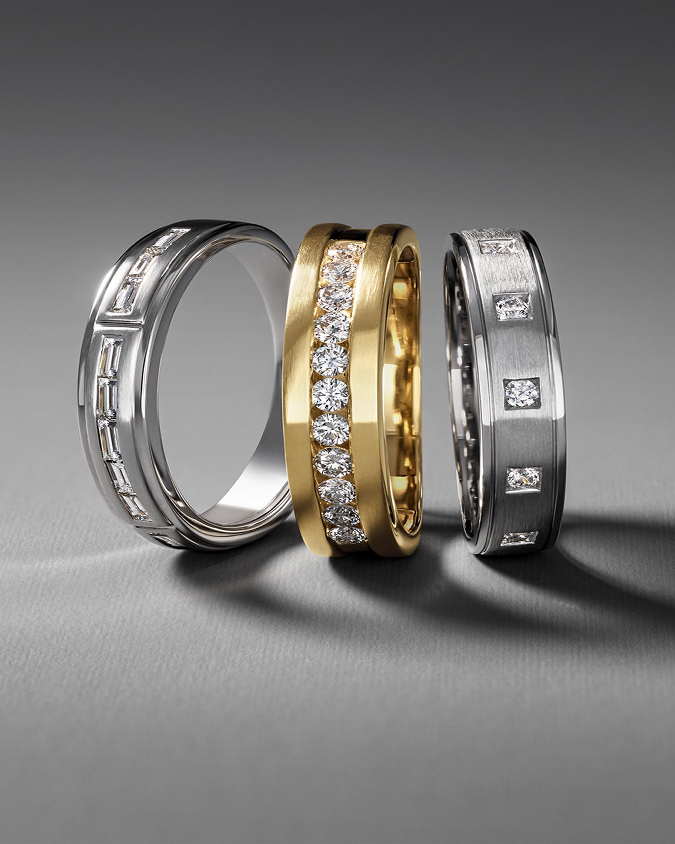 Kay men's diamond wedding band collection featuring yellow gold and white gold rings accented with round and baguette-cut diamonds, showcasing modern craftsmanship, refined textures and sophisticated style.