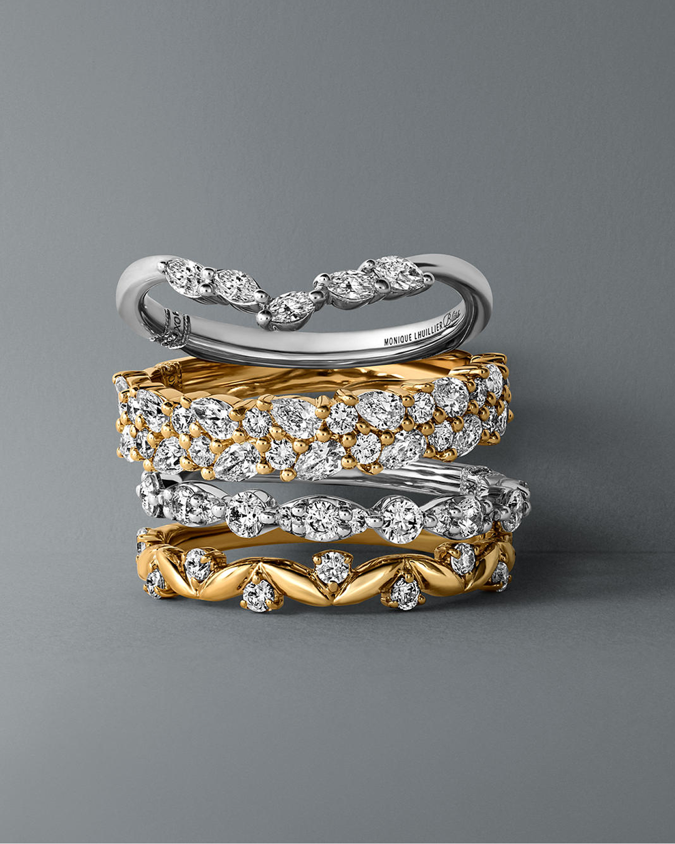 Kay diamond fashion ring collection featuring marquise-cut and round diamond bands in yellow gold and white gold, stacked to showcase intricate settings, mixed-metal styling and brilliant everyday sparkle.