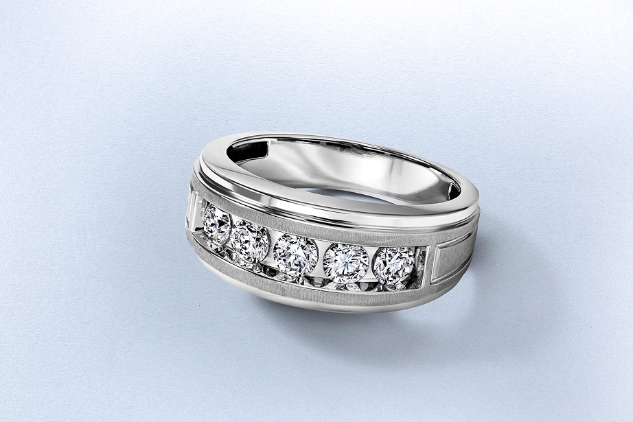 Kay men's diamond wedding band featuring five round brilliant diamonds channel-set in a contemporary white metal band with brushed and polished finishes, showcasing modern craftsmanship and refined everyday style.