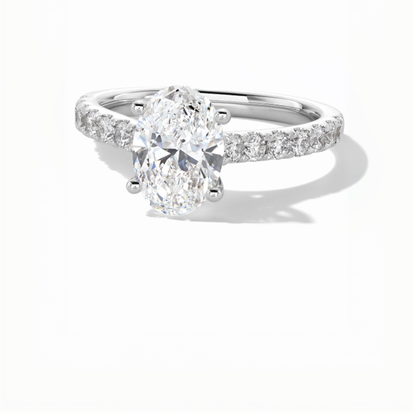 Kay Leo Diamond oval-cut engagement ring featuring a brilliant solitaire center diamond, four-prong setting, and pavé-set diamond band in polished white gold